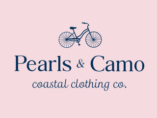 Logo of Pearls & Camo coastal clothing co. with a bicycle illustration on a pink background