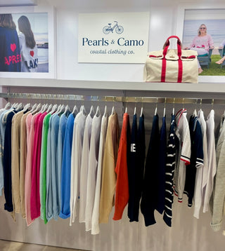 Display of clothing with 'Pearls & Camo' branding in the background